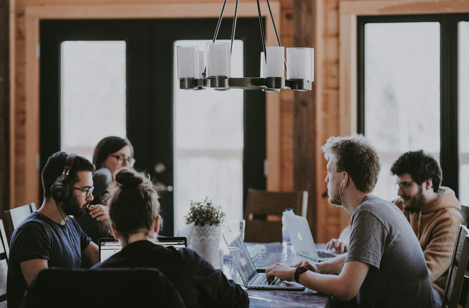 Colleagues working together around a table in a bright shared workspace
